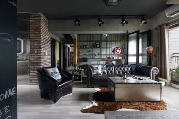 Modern living room with tufted leather sofa, industrial coffee table, and open shelving.