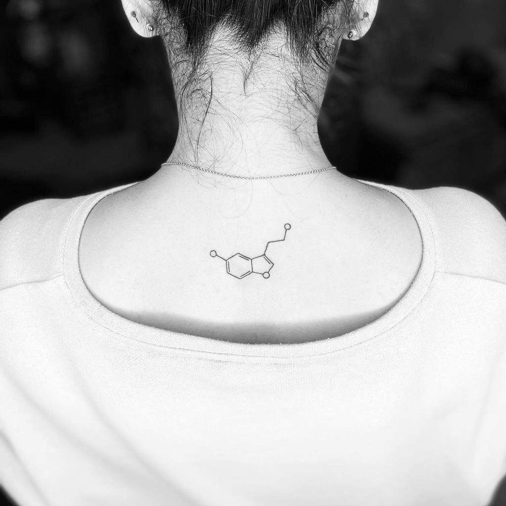 A neck tattoo of a serotonin chemical structure