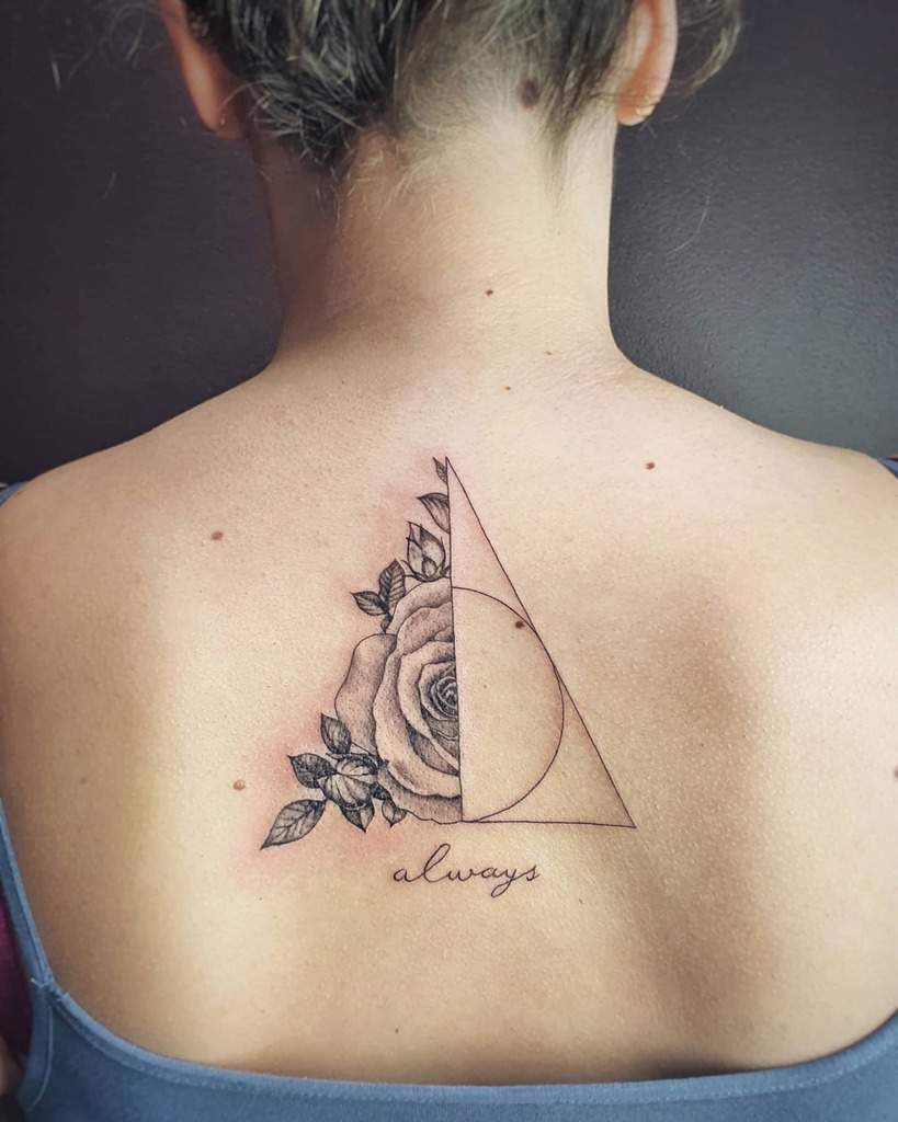 Elegant back tattoo featuring the Deathly Hallows symbol intertwined with a detailed rose and 'always' in cursive script