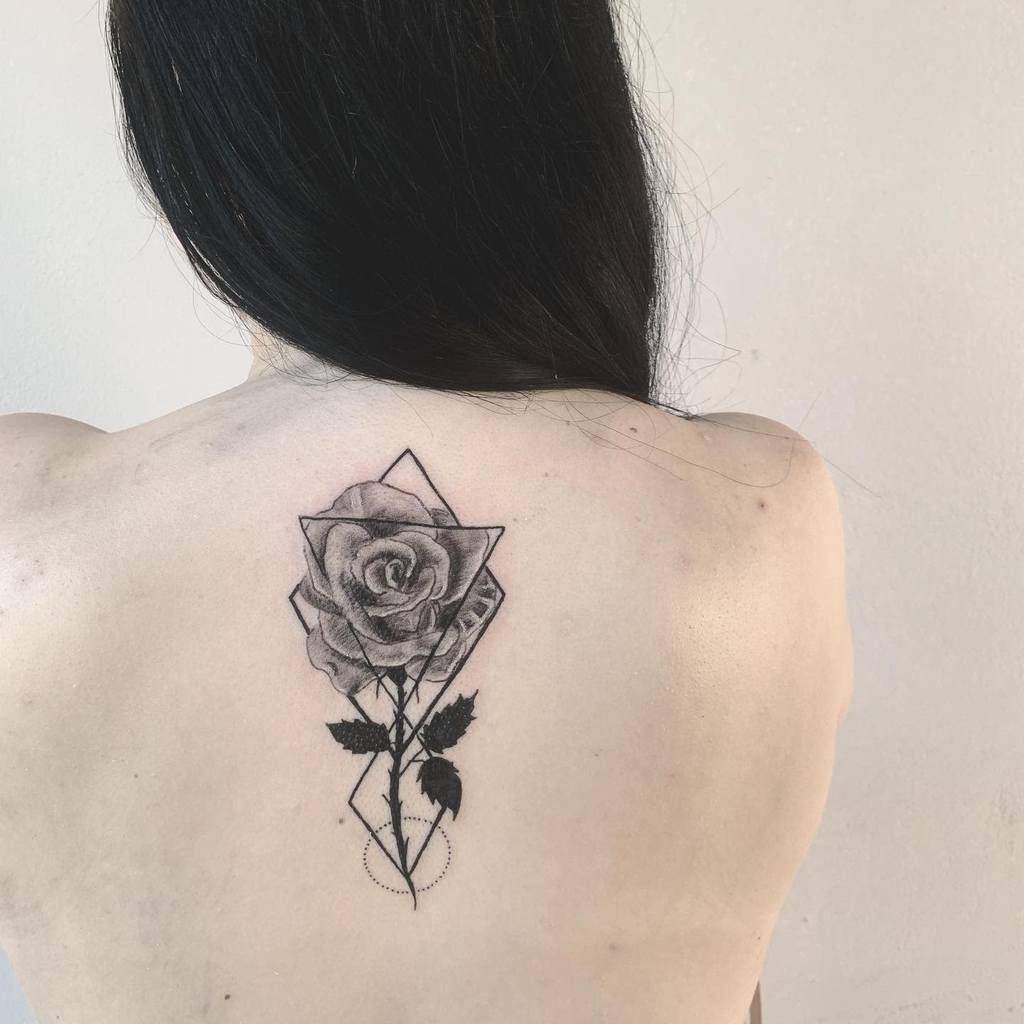 Woman with a geometric rose tattoo on her back