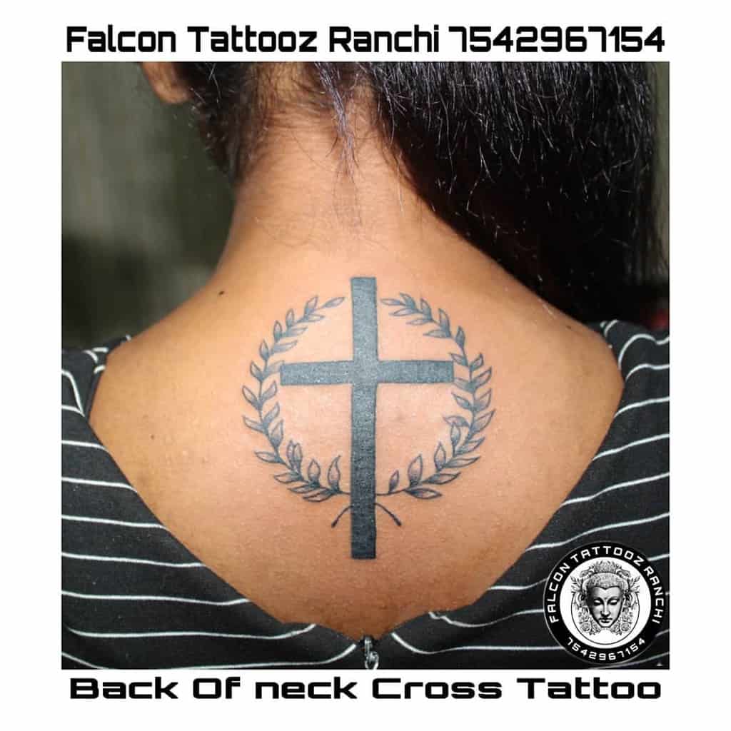 A striking cross tattoo with a laurel wreath adorns the neck