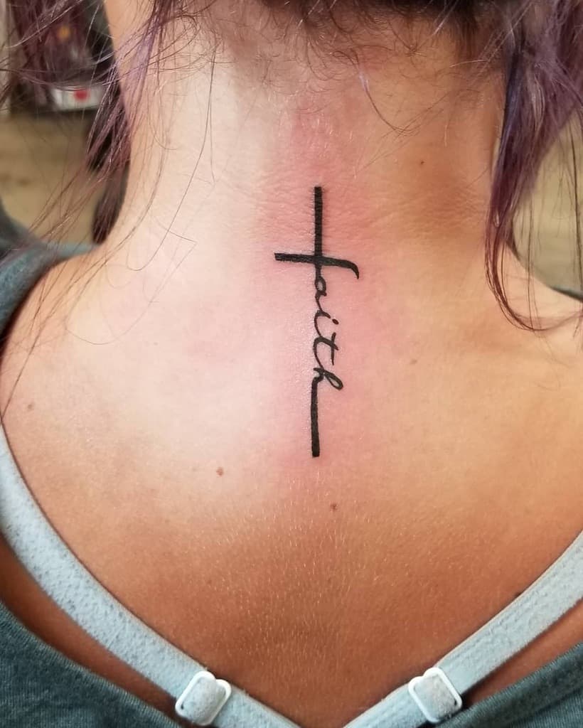 A tattoo intricately weaves the word "faith" into a cross, elegantly gracing the back of a person's neck