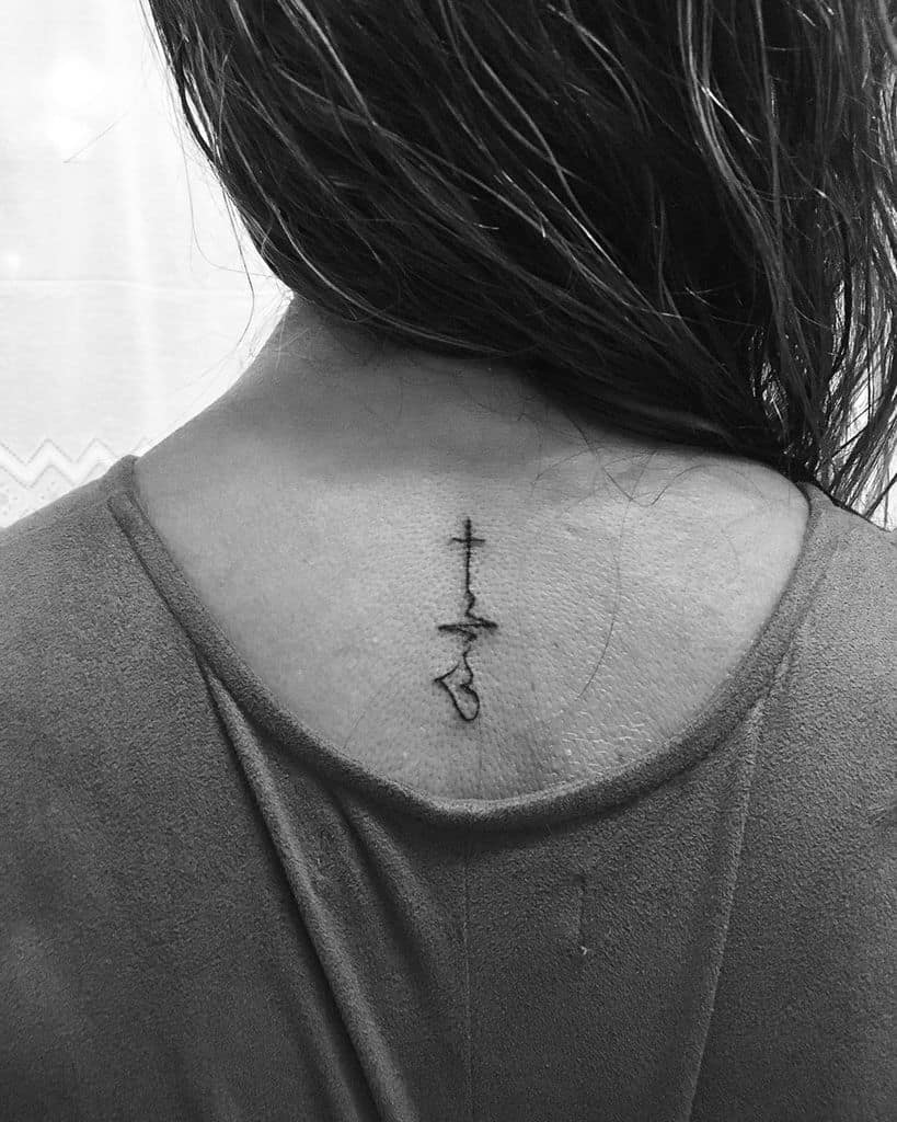 Minimalist back tattoo featuring a cross, heartbeat line, and heart symbol, combining faith, hope, and love in a vertical alignment