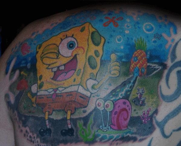 Colorful SpongeBob tattoo on shoulder showing him with Gary, giving a thumbs up in front of his pineapple house under the sea.