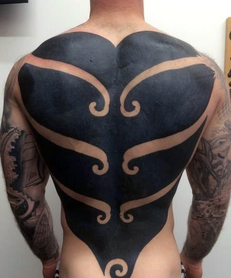 Person with a large abstract black tattoo covering their entire back