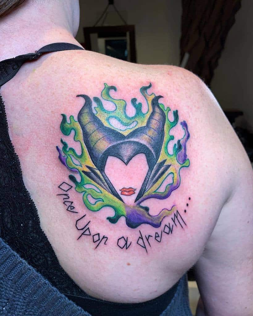 Back tattoo of Maleficent with horns, flames, and the words "Once Upon a Dream"