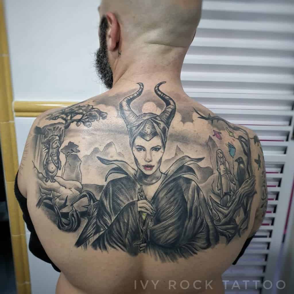 Epic full-back tattoo of Maleficent with intricate details, featuring her horns, dark cloak, and enchanted forest elements