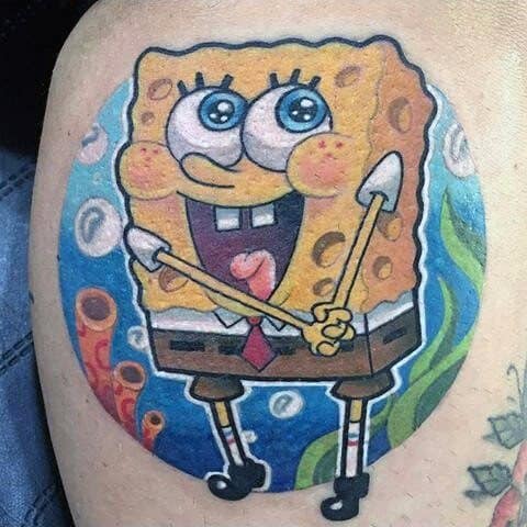 Bright SpongeBob tattoo inside a circular frame, with a joyful expression and bubbles, set against a colorful underwater background.