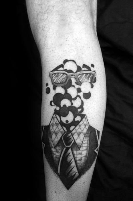 Black and white tattoo of a suit and tie with floating bubbles and sunglasses, creating a surreal and artistic design that combines a human form with abstract elements.