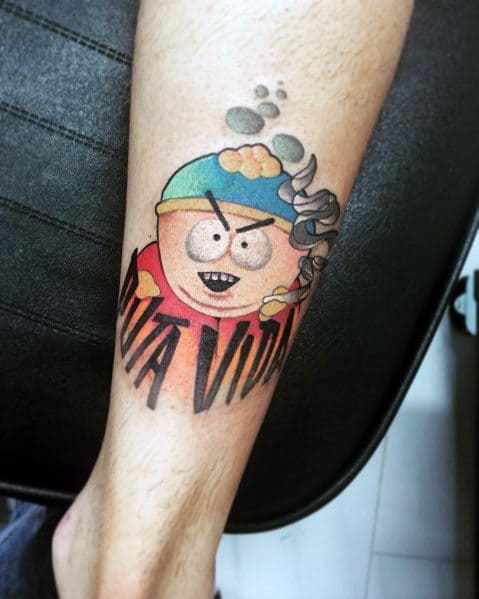 Cartman tattoo with 'Viva Vida' text and a dynamic design, featuring bold colors and shading for a striking South Park-inspired look.