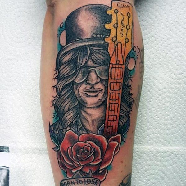 Colorful tattoo of Slash with a top hat, sunglasses, a Gibson guitar neck, red rose, and banner reading "Born to Lose" below.