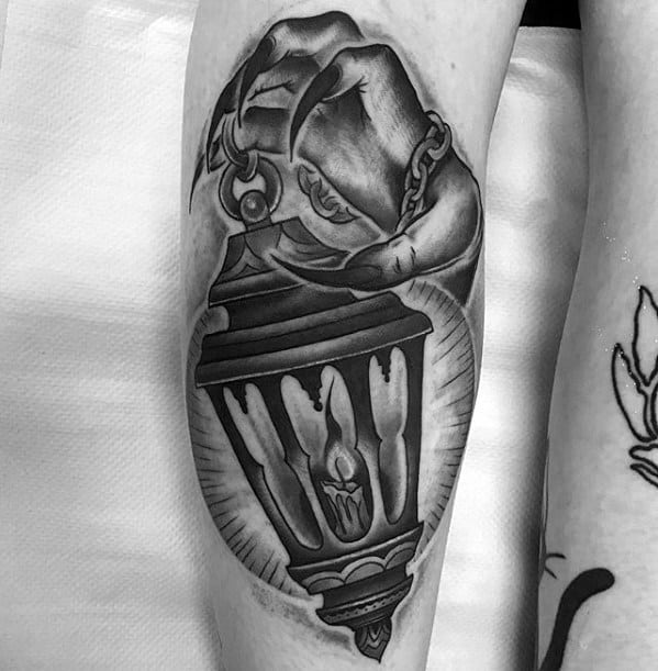 Back Of Leg Hand Holding Glowing Candle Lantern Male Tattoo Designs