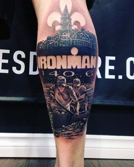 Alt text: Detailed tattoo featuring two men working with mining equipment, with the Ironman 1406 event and a fleur-de-lis symbol in the background.