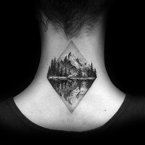 Realistic black and grey neck tattoo of a mountain landscape with pine trees reflected in a lake, enclosed within a geometric diamond shape.