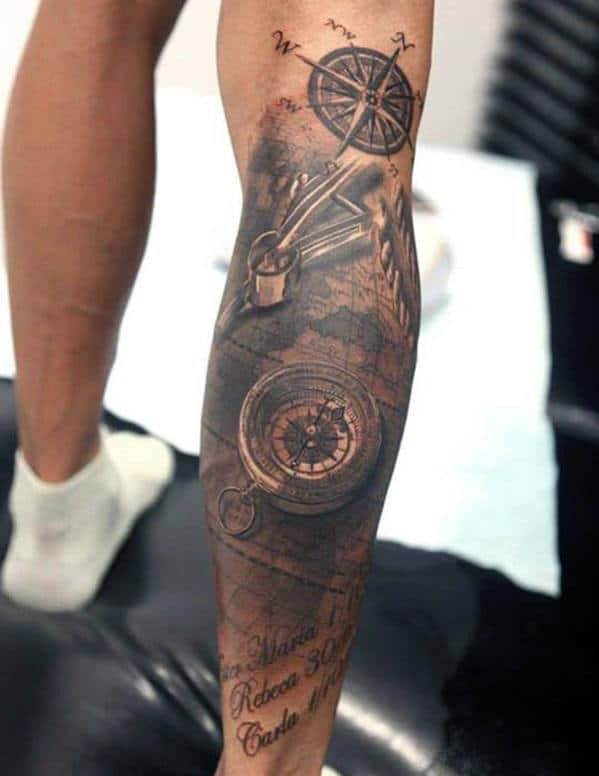 Leg tattoo featuring compasses, map, and nautical elements