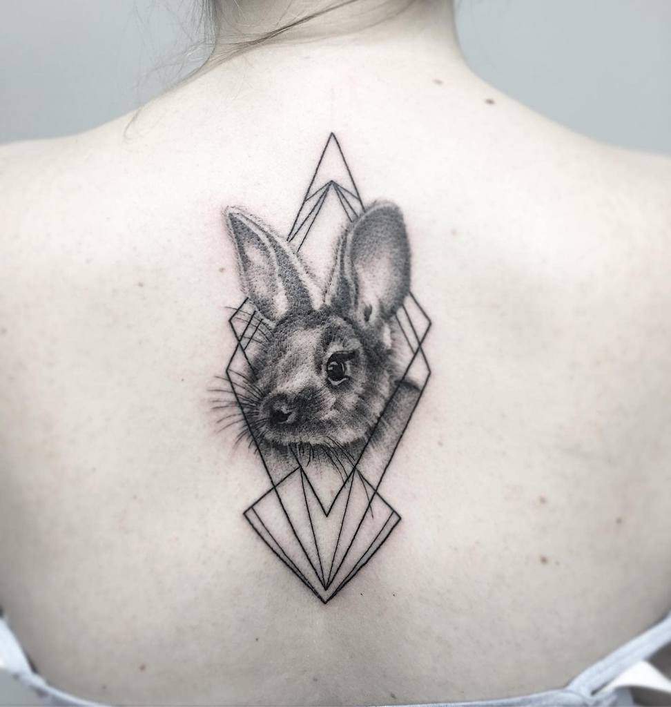 Tattoo of a rabbit framed by geometric shapes