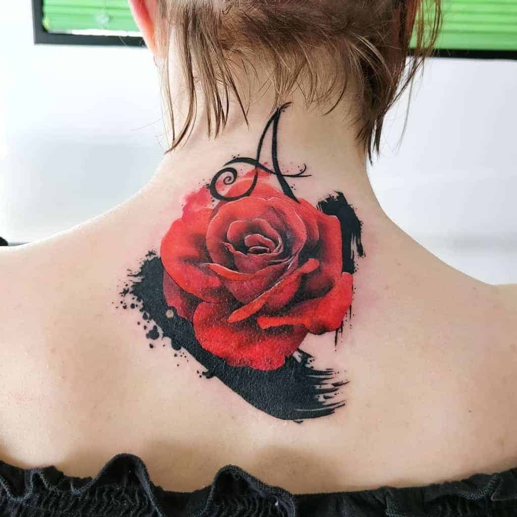A red rose tattoo with an "A" on the back of a person's neck