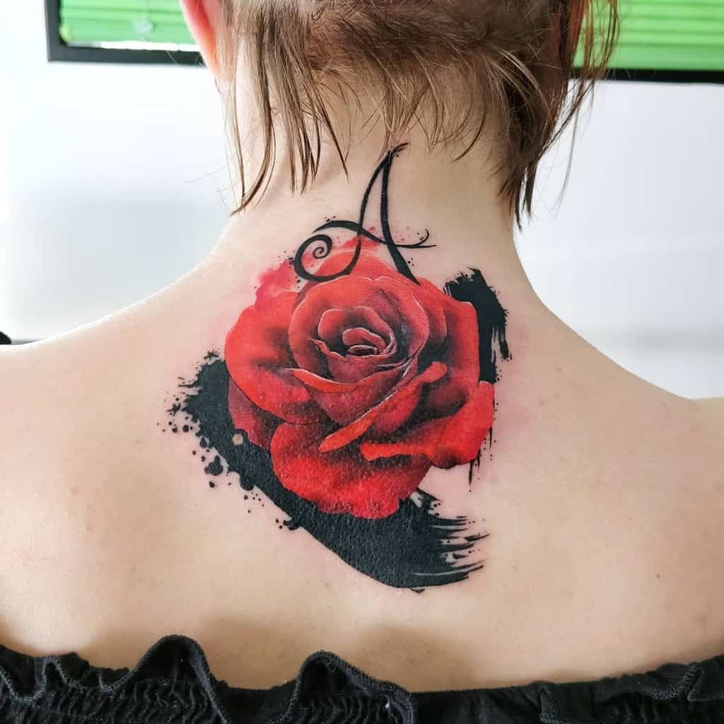 Tattoo of a red rose with the letter "A" on the back of their neck