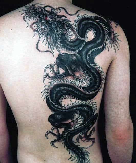 Intricate dragon tattoo spanning a person's back with dark, detailed shading