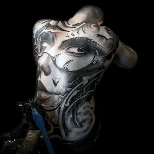 Person with a large, detailed black and gray tattoo covering their entire back