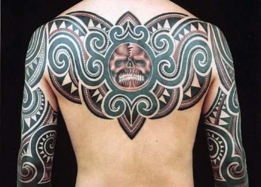 Tribal tattoo design covering a person's back and shoulders, featuring a skull