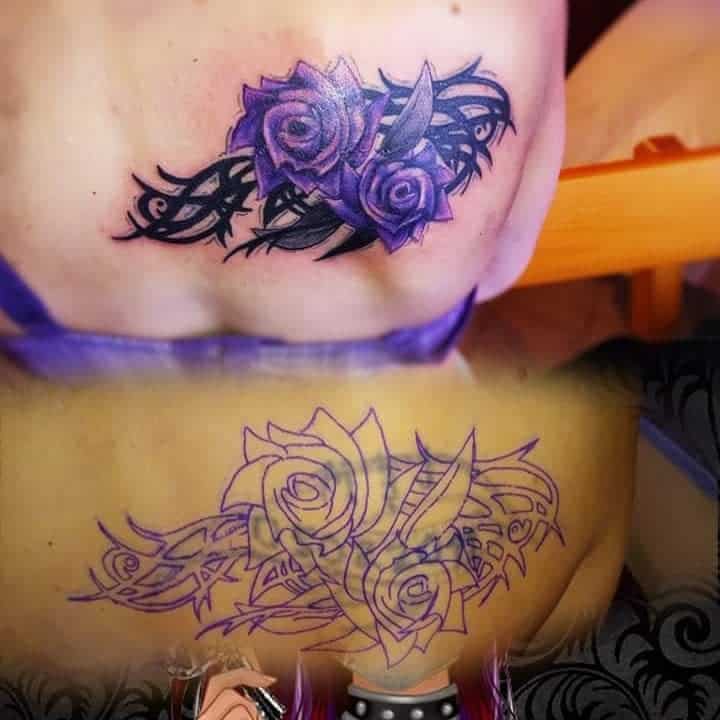 A stunning tattoo featuring a purple rose, vividly colored at the top and elegantly outlined at the bottom, complemented by intricate tribal design elements on the skin
