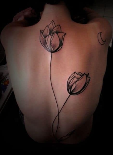 A large, black-line tulip tattoo across the back, featuring two elegant tulips with long stems and soft shading.