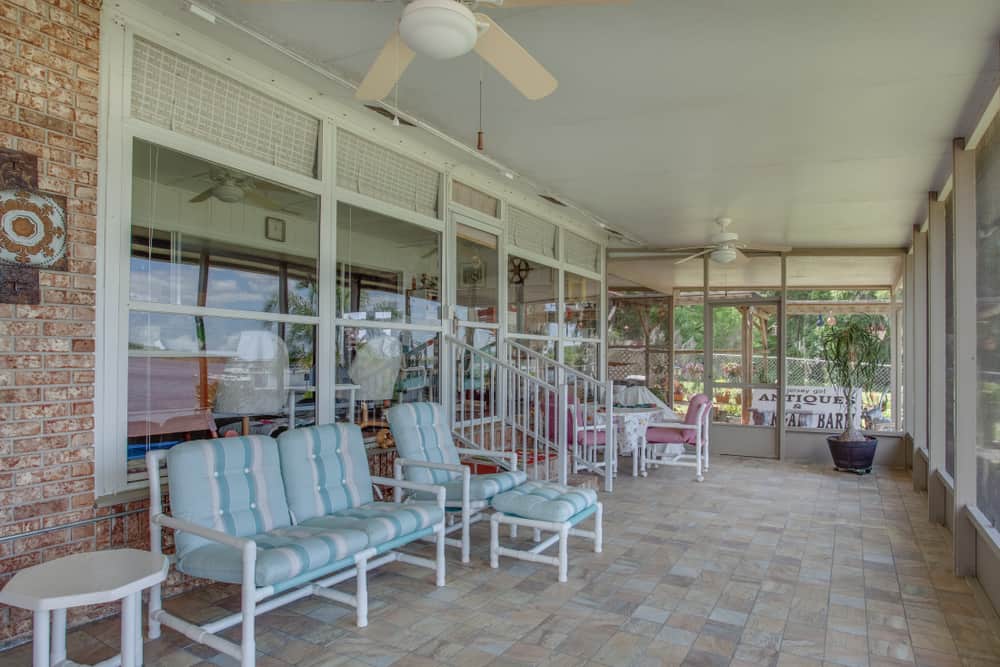 tile flooring backyard enclosed patio white outdoor furniture ceiling fan