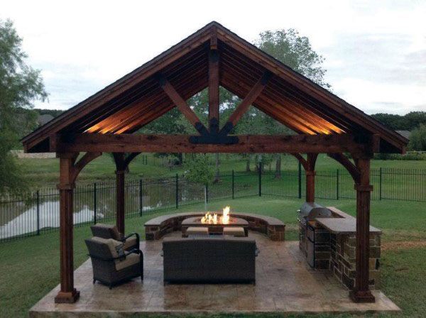 Elegant timber-framed pavilion with a central firepit, surrounded by comfortable outdoor seating.