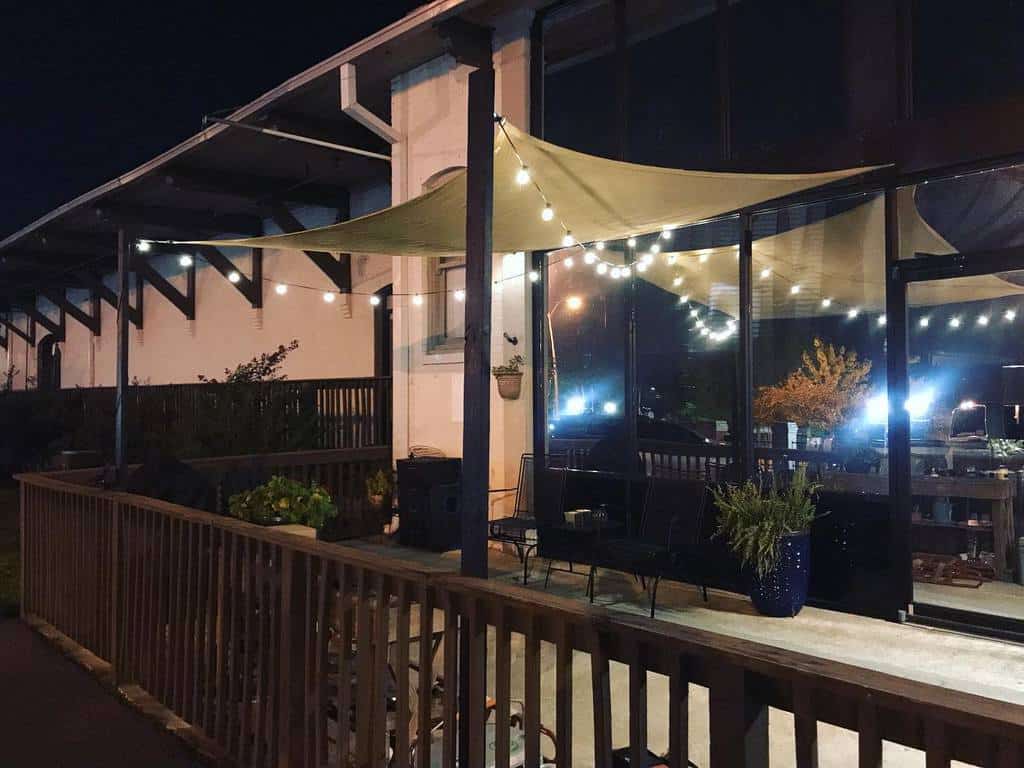 backyard patio wood deck with shade and string lights