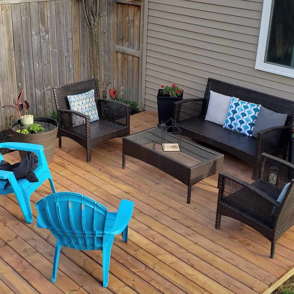 wood deck patio with wicker furniture and blue accent chairs