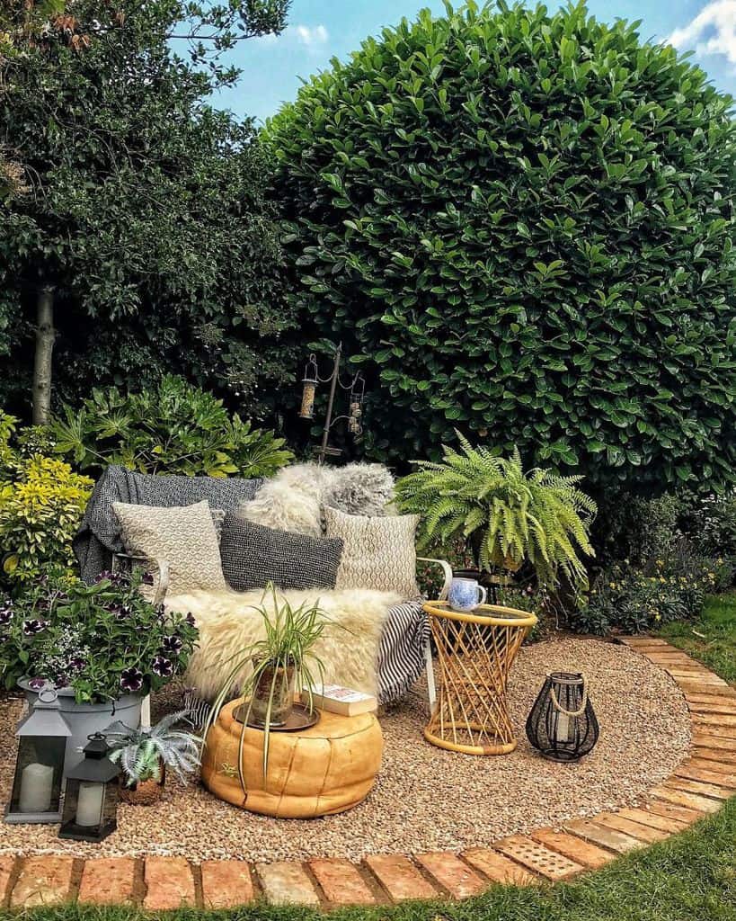 backyard gravel patio with brick edging and sofa