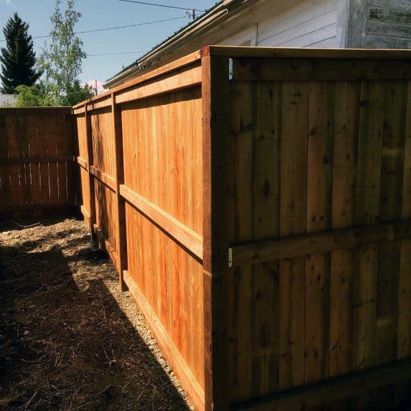 Vertical wooden fence casting intricate shadows in the garden area