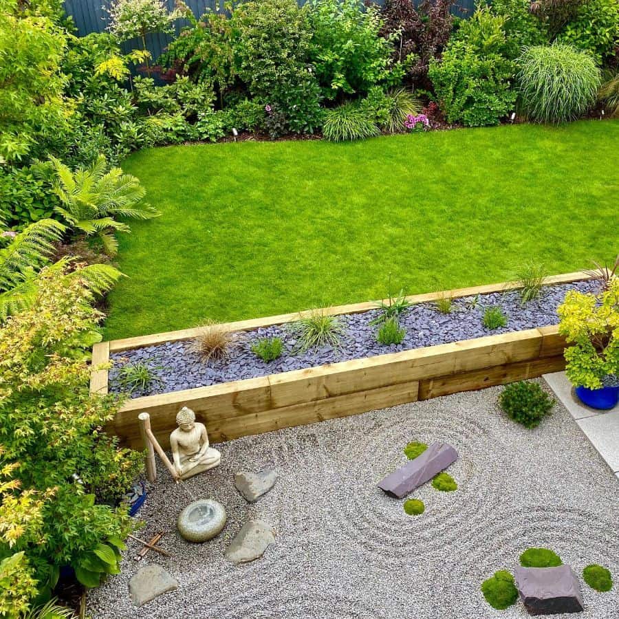aerial shot of large grass backyard with japanese stone zen garden 