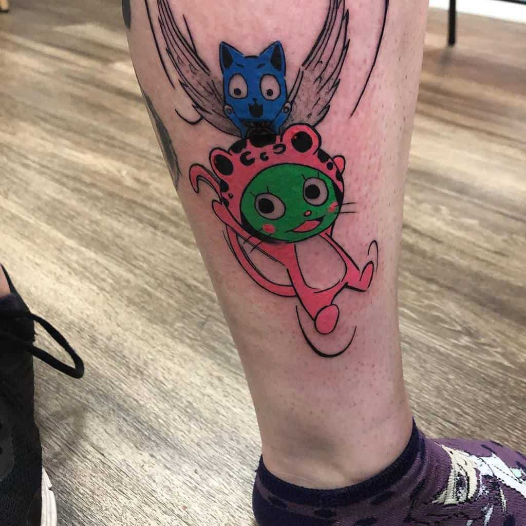 Colorful tattoo of Happy and Frosch from Fairy Tail on the leg, featuring playful expressions and vibrant pink, green, and blue tones.