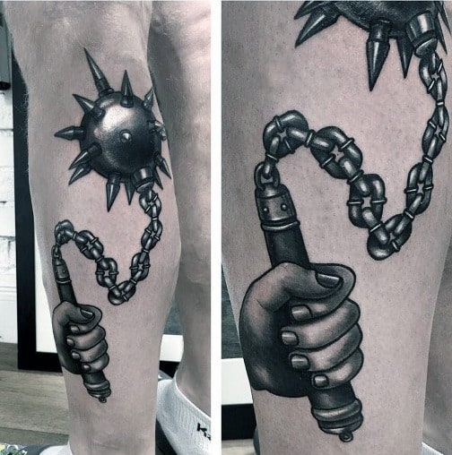 Realistic black and gray mace tattoo featuring a detailed hand gripping the handle, with a spiked ball on a chain, symbolizing strength.