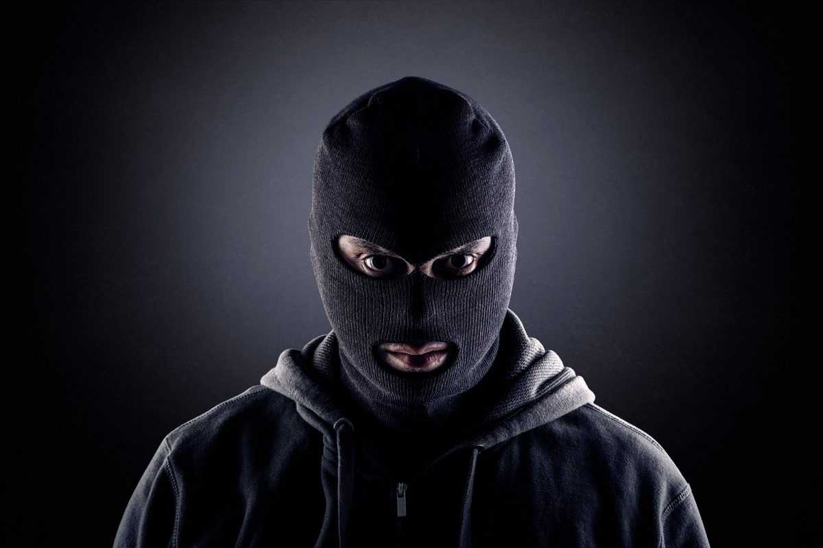 Criminal,Wearing,Black,Balaclava,And,Hoodie,In,The,Dark