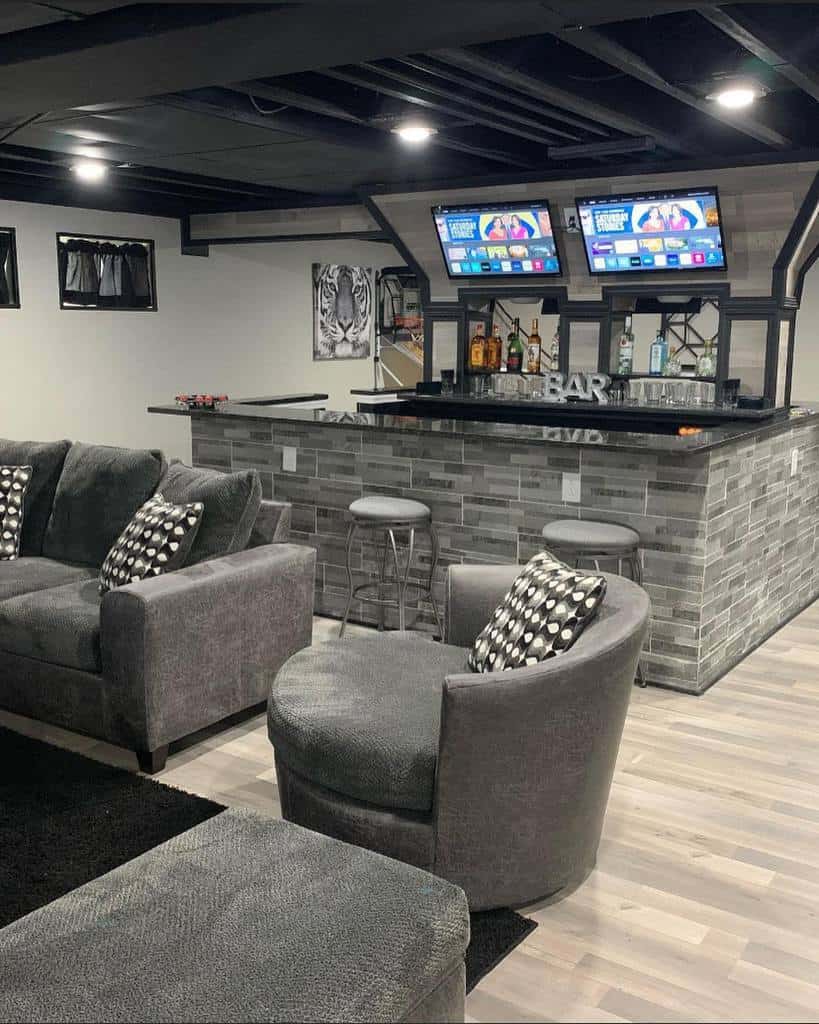luxury gray basement bar with sofas and tv screens