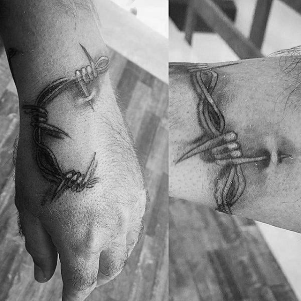 Barbed Wire Poking Into Sin Mens Hand Tattoo Ideas
