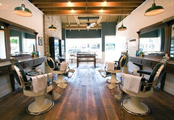 Classic barbershop with vintage chairs, wooden floors, and exposed ceiling beams.
