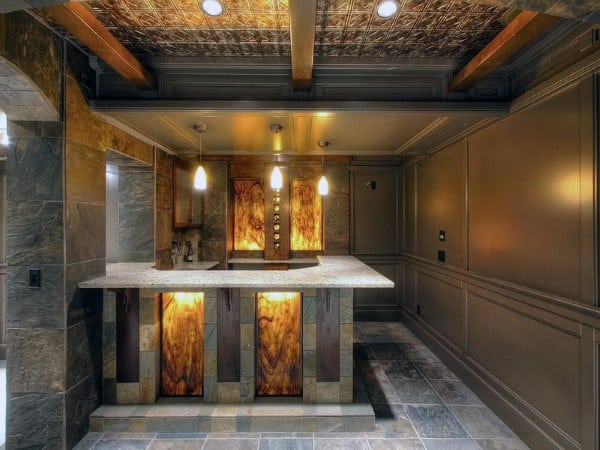 Elegant basement bar with tin ceiling tiles, exposed wooden beams, and warm ambient lighting.