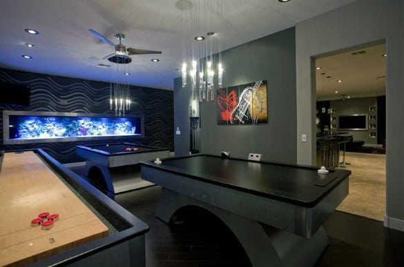 Man cave with air hockey, shuffleboard tables, modern lighting, and wall art