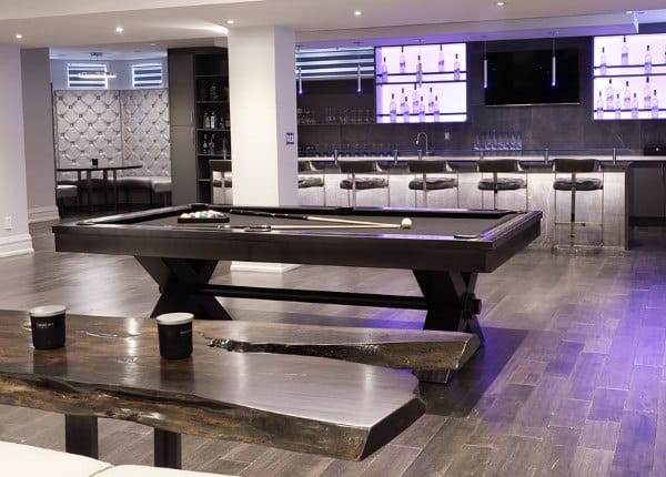 Luxury basement with pool table, sleek bar area, modern seating, and recessed lighting.
