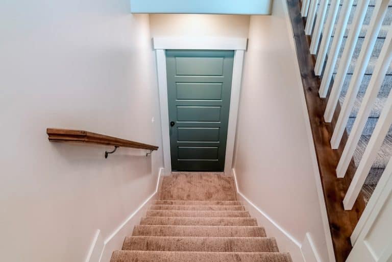 basement stairs leading to green door