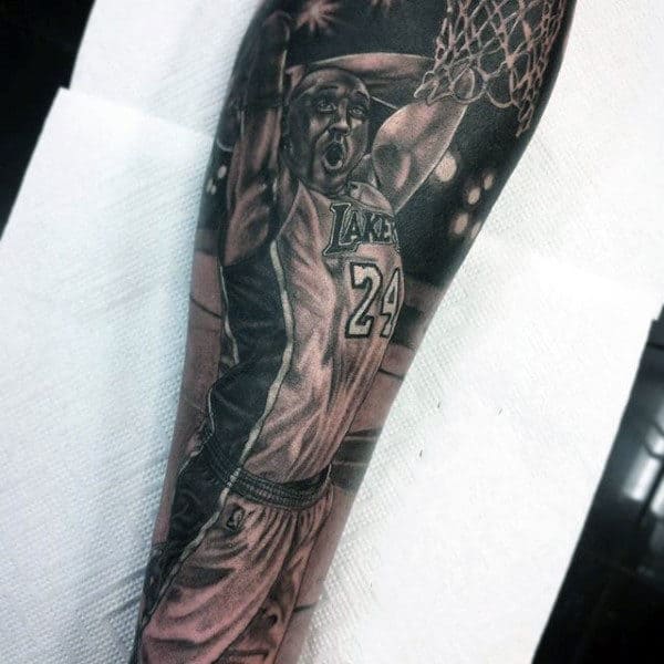 Tattoo of a basketball player in a Los Angeles Lakers jersey, number 24, dunking a ball