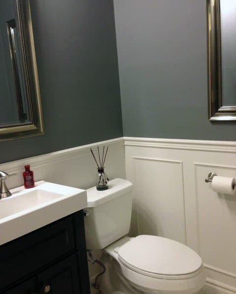 Stylish bathroom with gray walls, white chair rail molding, and modern fixtures for a clean and elegant design