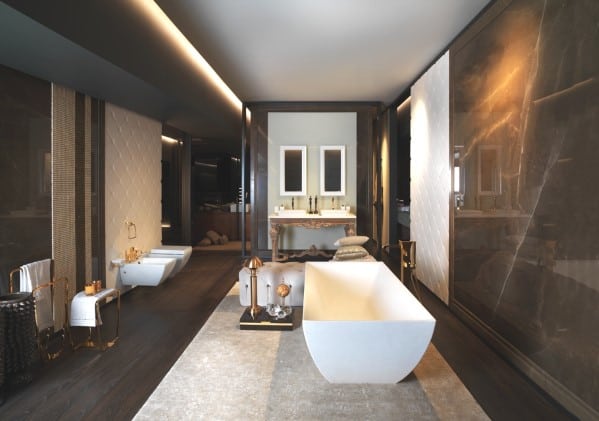 Luxurious bathroom with freestanding tub, double vanity, and dark marble walls.