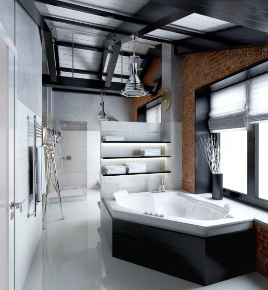 Industrial-style bathroom with corner bathtub, exposed brick wall, and modern lighting.