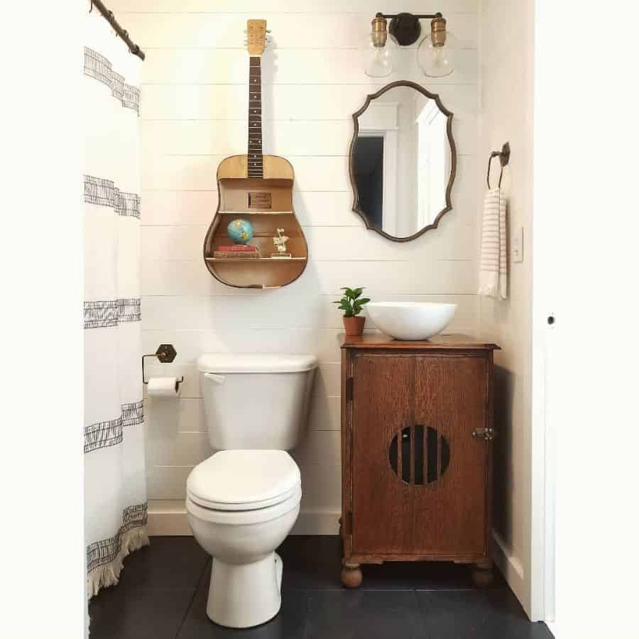 small vintage bathroom with unique guitar wall shelf