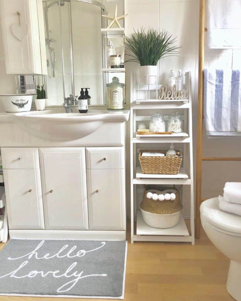 Modern bathroom with "Hello Lovely" rug, open shelving, and decorative plants.